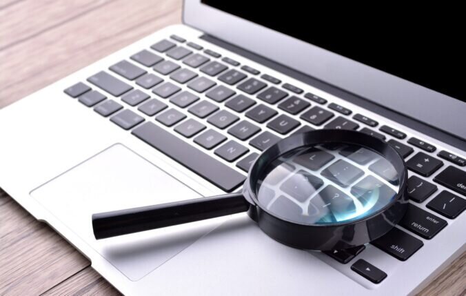 Laptop with magnifying glass
